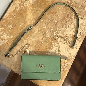 Anne Klein sage green crossbody with 3 card slots and a zipper compartment.